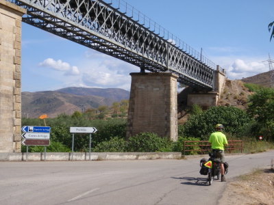 Road intersection, creek, and railroad bridge.